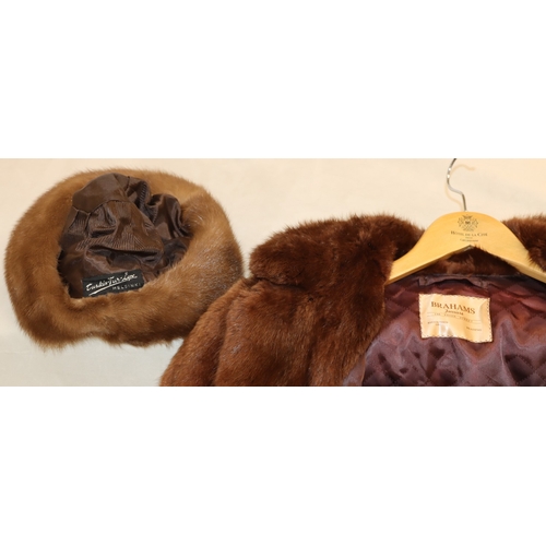 3029 - A mid length fur coat with belt, Brahams Furriers label, 88cm long, shoulder to cuff length 60cm lon... 