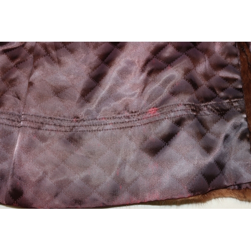 3029 - A mid length fur coat with belt, Brahams Furriers label, 88cm long, shoulder to cuff length 60cm lon... 