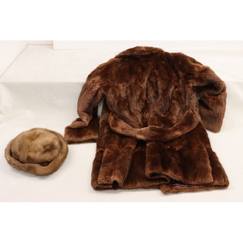 3029 - A mid length fur coat with belt, Brahams Furriers label, 88cm long, shoulder to cuff length 60cm lon... 