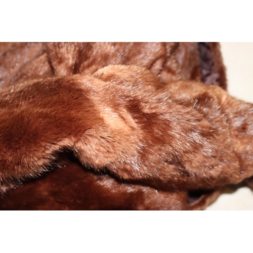 3029 - A mid length fur coat with belt, Brahams Furriers label, 88cm long, shoulder to cuff length 60cm lon... 