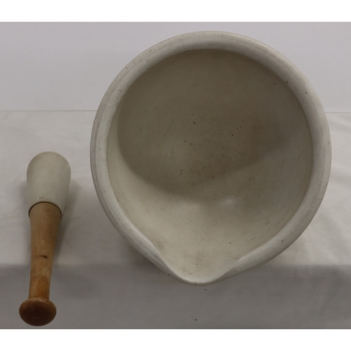 3032 - A large stone pestle and mortar, 29cm diameter, 15.5cm high, pestle, 31cm long.