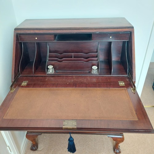3011 - THIS LOT IS NOT HELD BY PFW. A mahogany bureau, 3 drawers, interior writing slope with leather inser... 