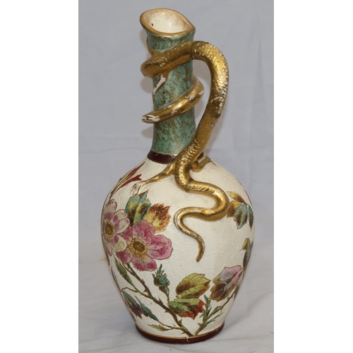 143 - A Bonn glazed china round bulbous thin necked jug with serpent handle, on white and green ground wit... 