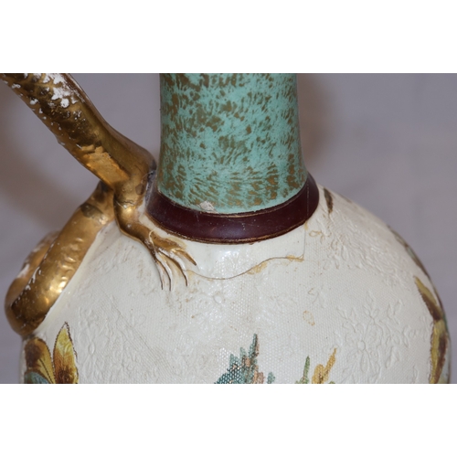 143 - A Bonn glazed china round bulbous thin necked jug with serpent handle, on white and green ground wit... 