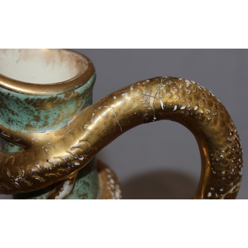 143 - A Bonn glazed china round bulbous thin necked jug with serpent handle, on white and green ground wit... 