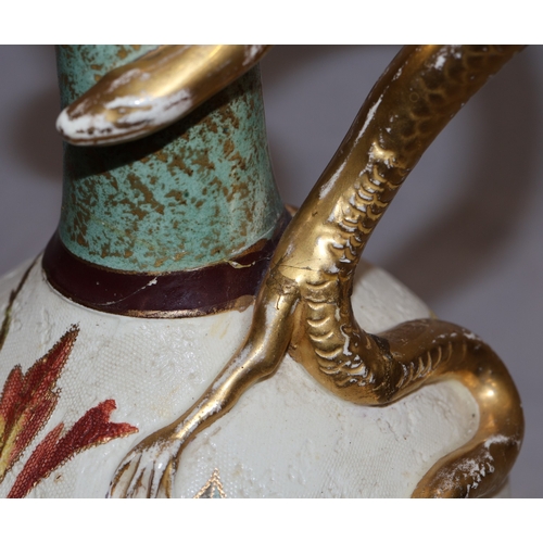 143 - A Bonn glazed china round bulbous thin necked jug with serpent handle, on white and green ground wit... 