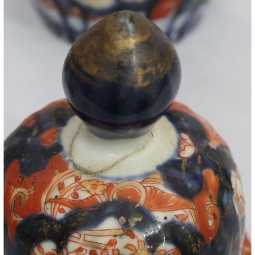 179 - A set of 3 Imari round bulbous melon shaped lidded pots with allover tree, floral, leaf and gilt dec... 