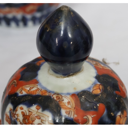 179 - A set of 3 Imari round bulbous melon shaped lidded pots with allover tree, floral, leaf and gilt dec... 