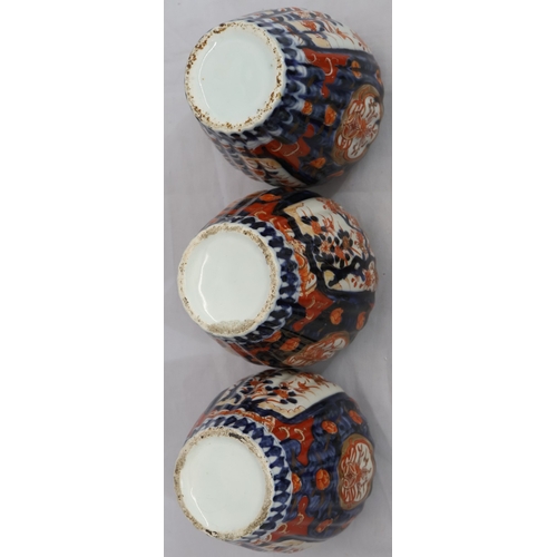 179 - A set of 3 Imari round bulbous melon shaped lidded pots with allover tree, floral, leaf and gilt dec... 
