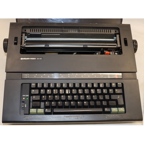 3108 - A Silver-Reed EX43 Electronic Compact Typewriter with protective cover and operating manual.