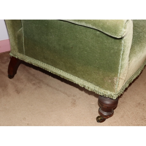3203 - THIS ITEM IS NOT HELD BY PFW. A green upholstered low chair on castors, 85cm wide, 80cm deep, 84cm h... 