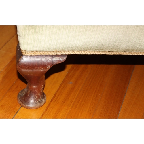 3225 - THIS ITEM IS NOT HELD BY PFW. A wing back green upholstered armchair, 76cm wide, 69cm deep, 97cm hig... 