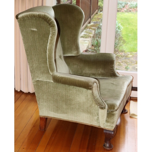 3225 - THIS ITEM IS NOT HELD BY PFW. A wing back green upholstered armchair, 76cm wide, 69cm deep, 97cm hig... 