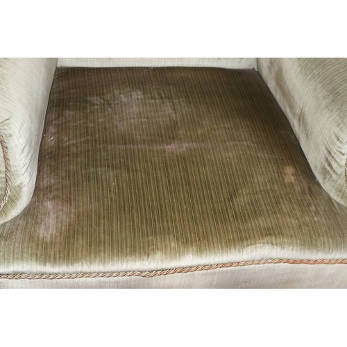 3225 - THIS ITEM IS NOT HELD BY PFW. A wing back green upholstered armchair, 76cm wide, 69cm deep, 97cm hig... 