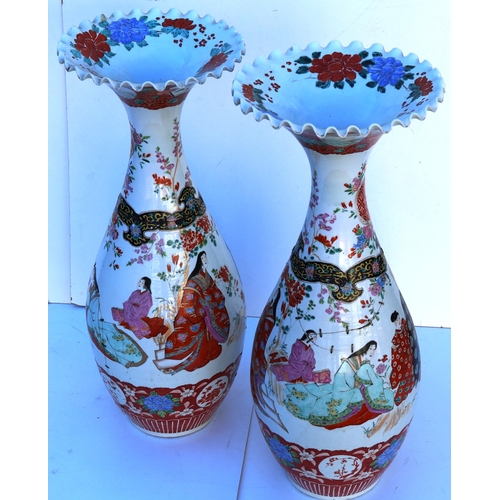 103 - A pair of large round bulbous thin necked trumpet shaped floor vases with crinkled rims, on white gr... 