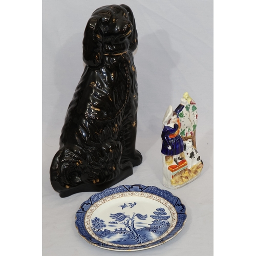 104 - A Victorian black Staffordshire large china figure of a seated Spaniel with gilt decoration, 35cm hi... 