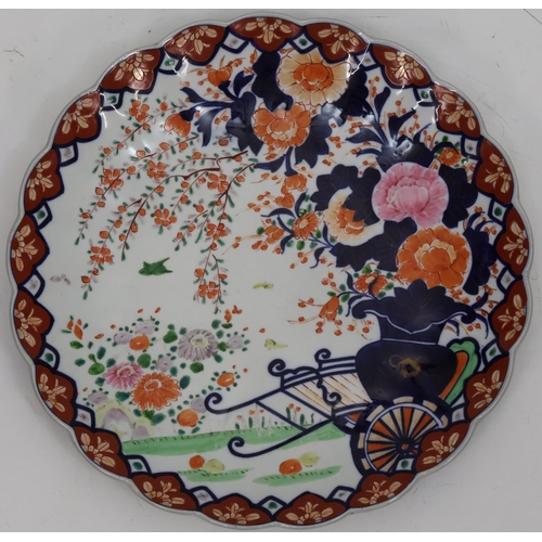 105 - An Imari round scallop shaped charger on white, red and blue ground with garden and bird decoration,... 