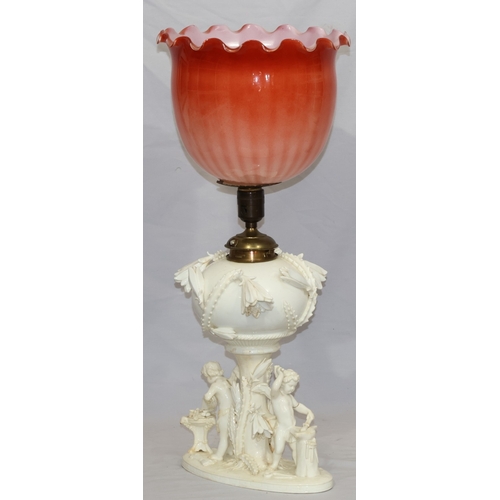 107 - A Moore Brothers white china round bulbous shaped oil lamp with allover raised cupid, floral, leaf a... 