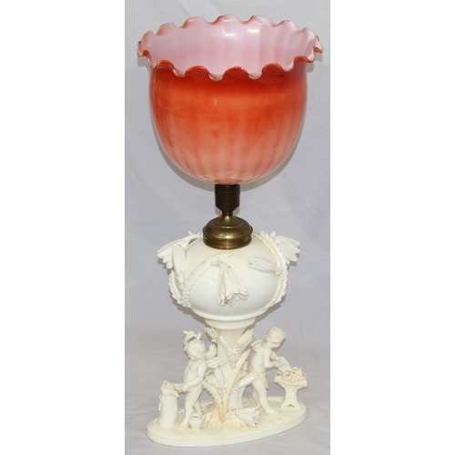 107 - A Moore Brothers white china round bulbous shaped oil lamp with allover raised cupid, floral, leaf a... 