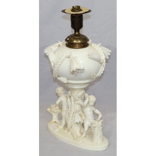 107 - A Moore Brothers white china round bulbous shaped oil lamp with allover raised cupid, floral, leaf a... 