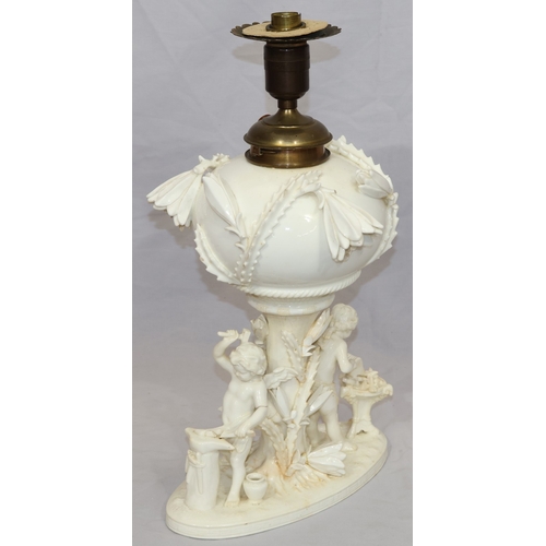 107 - A Moore Brothers white china round bulbous shaped oil lamp with allover raised cupid, floral, leaf a... 