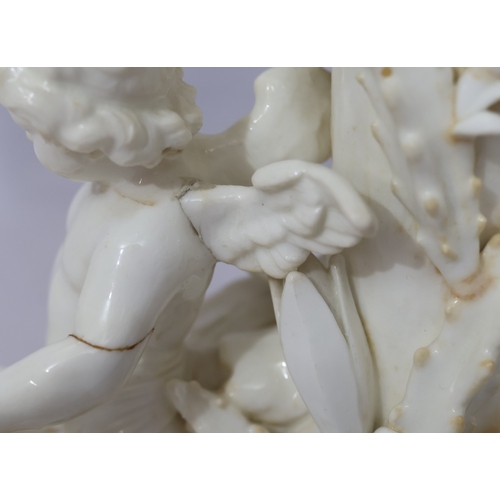 107 - A Moore Brothers white china round bulbous shaped oil lamp with allover raised cupid, floral, leaf a... 