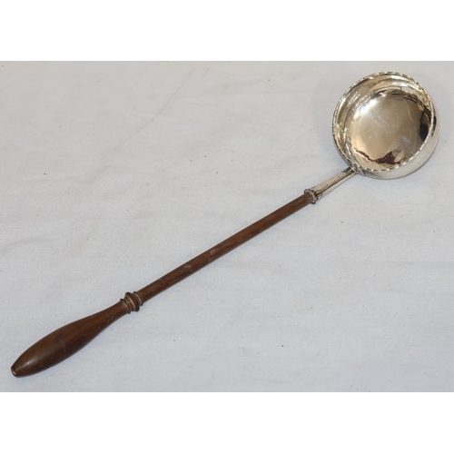 393 - A Georgian silver coloured metal round bulbous shaped punch ladle with turned wooden handle, engrave... 