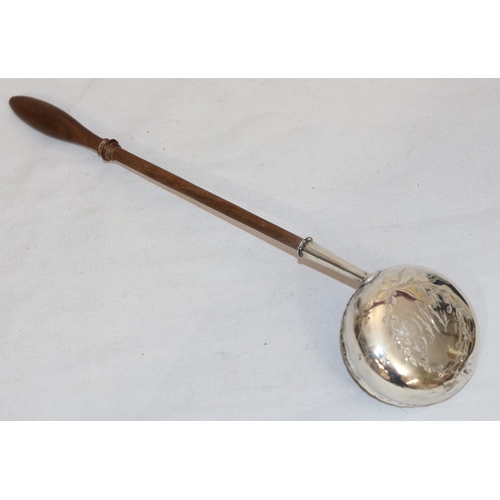 393 - A Georgian silver coloured metal round bulbous shaped punch ladle with turned wooden handle, engrave... 