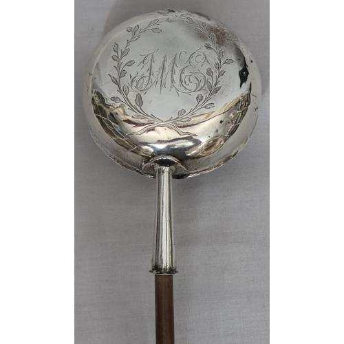393 - A Georgian silver coloured metal round bulbous shaped punch ladle with turned wooden handle, engrave... 