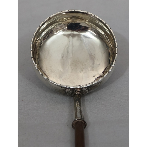 393 - A Georgian silver coloured metal round bulbous shaped punch ladle with turned wooden handle, engrave... 