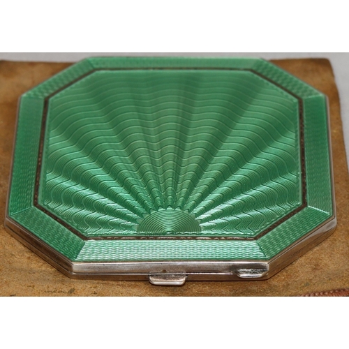 394 - A Birmingham silver and green enamelled square compact with chamfer corners, hinged lid enclosing mi... 
