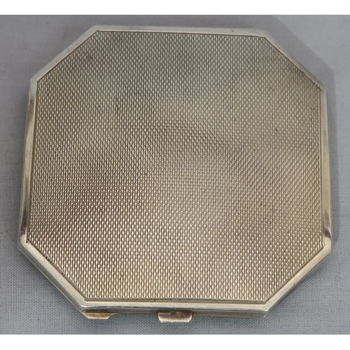 394 - A Birmingham silver and green enamelled square compact with chamfer corners, hinged lid enclosing mi... 