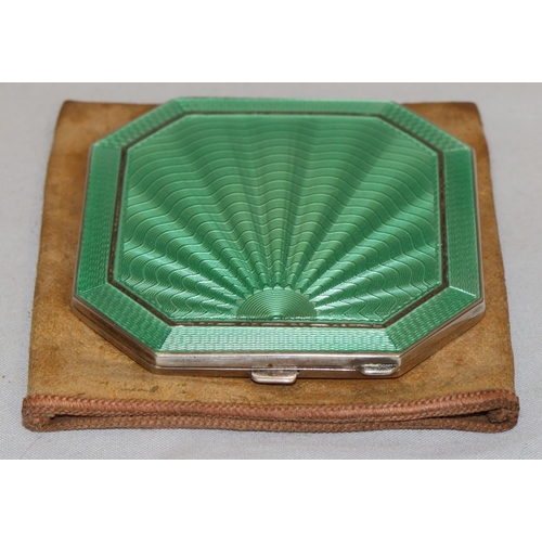 394 - A Birmingham silver and green enamelled square compact with chamfer corners, hinged lid enclosing mi... 