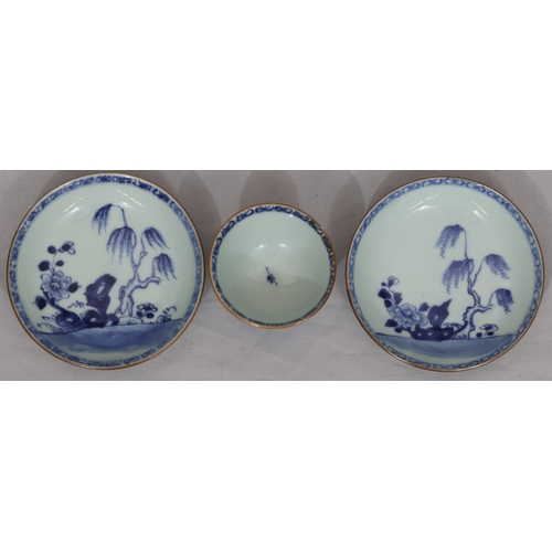 66 - An 18th Century Chinese tea bowl on blue and white ground and 2 matching saucers with branch, floral... 