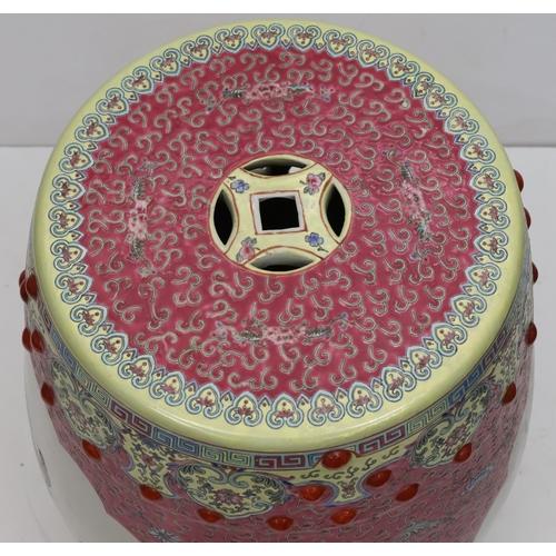 67 - An Oriental large round bulbous shaped garden seat on pink and yellow ground, panels with multi-colo... 