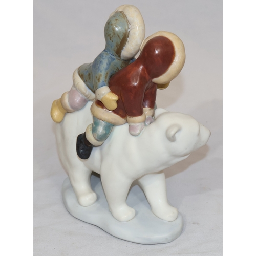 74 - A Lladro mat group of 2 Eskimo children on back of Polar Bear, 18cm high