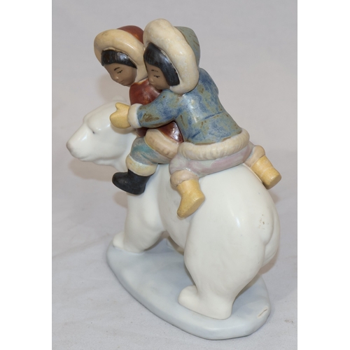 74 - A Lladro mat group of 2 Eskimo children on back of Polar Bear, 18cm high