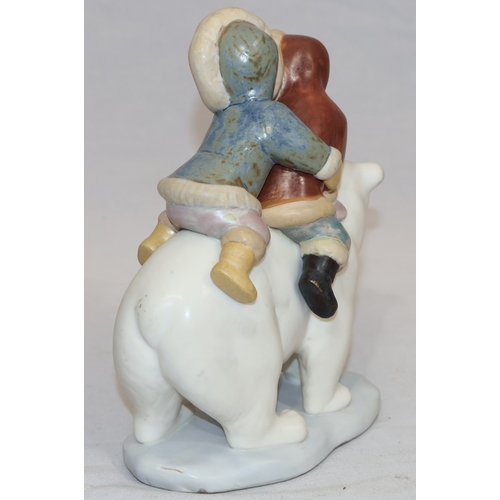 74 - A Lladro mat group of 2 Eskimo children on back of Polar Bear, 18cm high