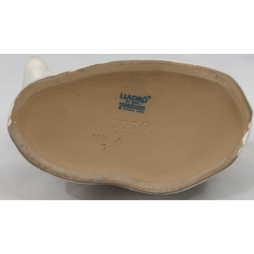 74 - A Lladro mat group of 2 Eskimo children on back of Polar Bear, 18cm high