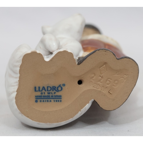 75 - A Lladro mat group of Eskimo standing next to baby Polar Bear, 15cm high