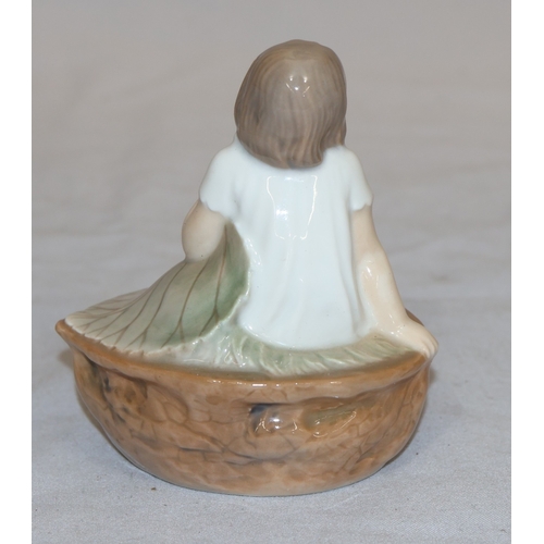 86 - A Royal Copenhagen small figure of a young girl seated in a basket holding a large leaf no. 4374, 9c... 