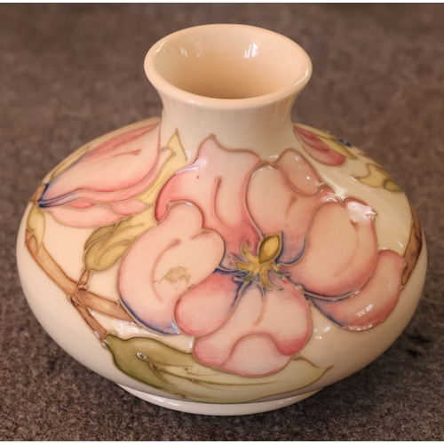 92 - A Moorcroft round squat thin necked trumpet shaped vase on cream ground with multi-coloured floral, ... 