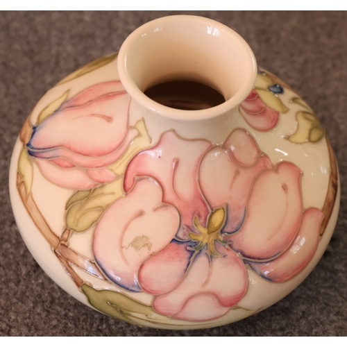 92 - A Moorcroft round squat thin necked trumpet shaped vase on cream ground with multi-coloured floral, ... 