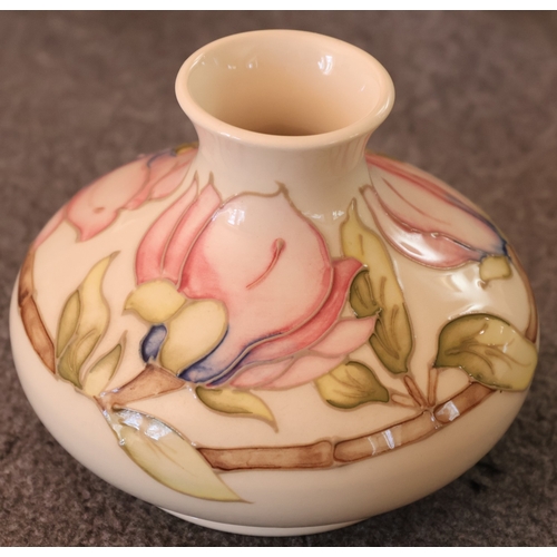 92 - A Moorcroft round squat thin necked trumpet shaped vase on cream ground with multi-coloured floral, ... 