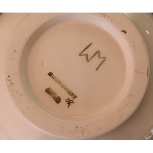 92 - A Moorcroft round squat thin necked trumpet shaped vase on cream ground with multi-coloured floral, ... 