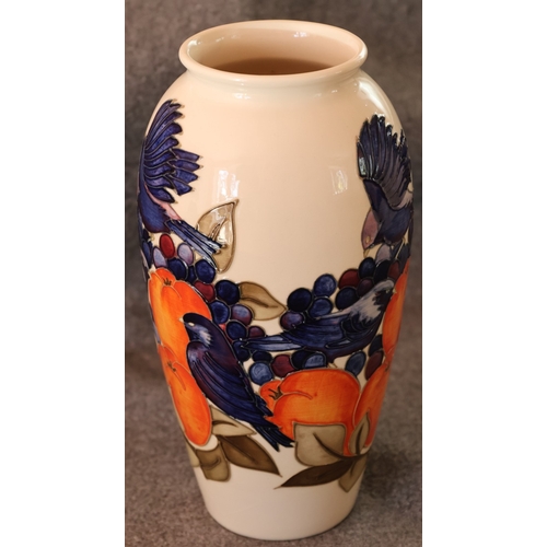 95 - A Moorcroft round bulbous thin necked trumpet shaped Finches and Fruit pattered vase, 25.5cm high