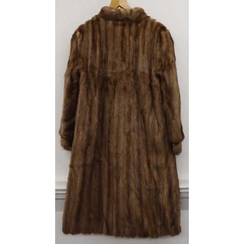 4015 - A light brown fur coat, size 12 label (small), 113cm long. shoulder to sleeve, 60cm. (Some loose sti... 