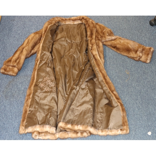 4015 - A light brown fur coat, size 12 label (small), 113cm long. shoulder to sleeve, 60cm. (Some loose sti... 