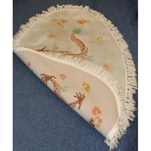 4068 - An oval Oriental rug on beige ground with dragon to centre, 175cm x 116cm overall.