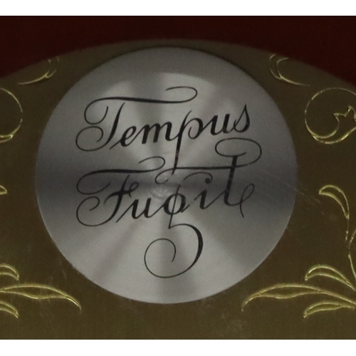 4088 - A Hermle reproduction mahogany mantel clock, 25cm high.